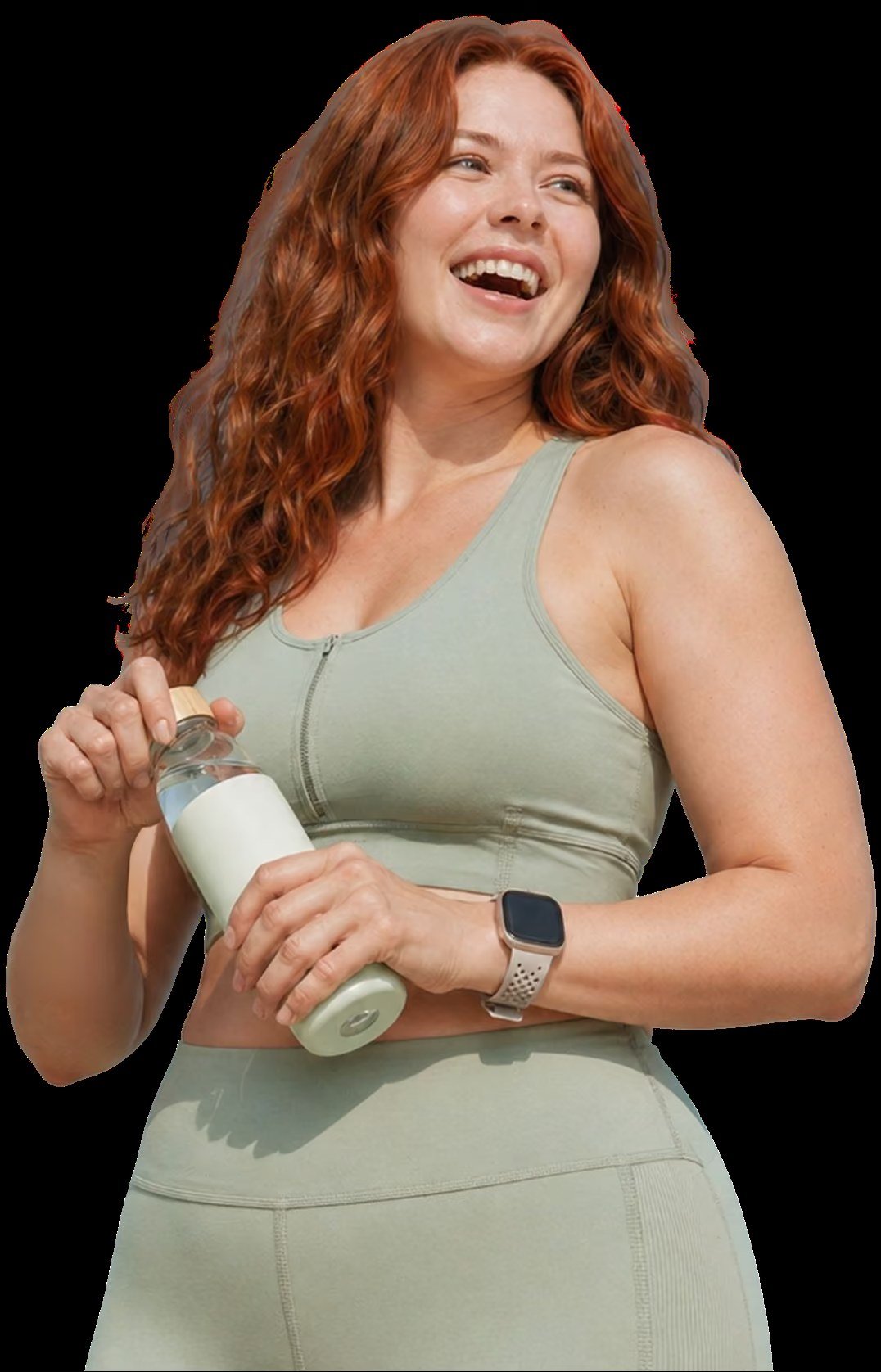 Smiling woman in workout clothes holding a water bottle against a dark background